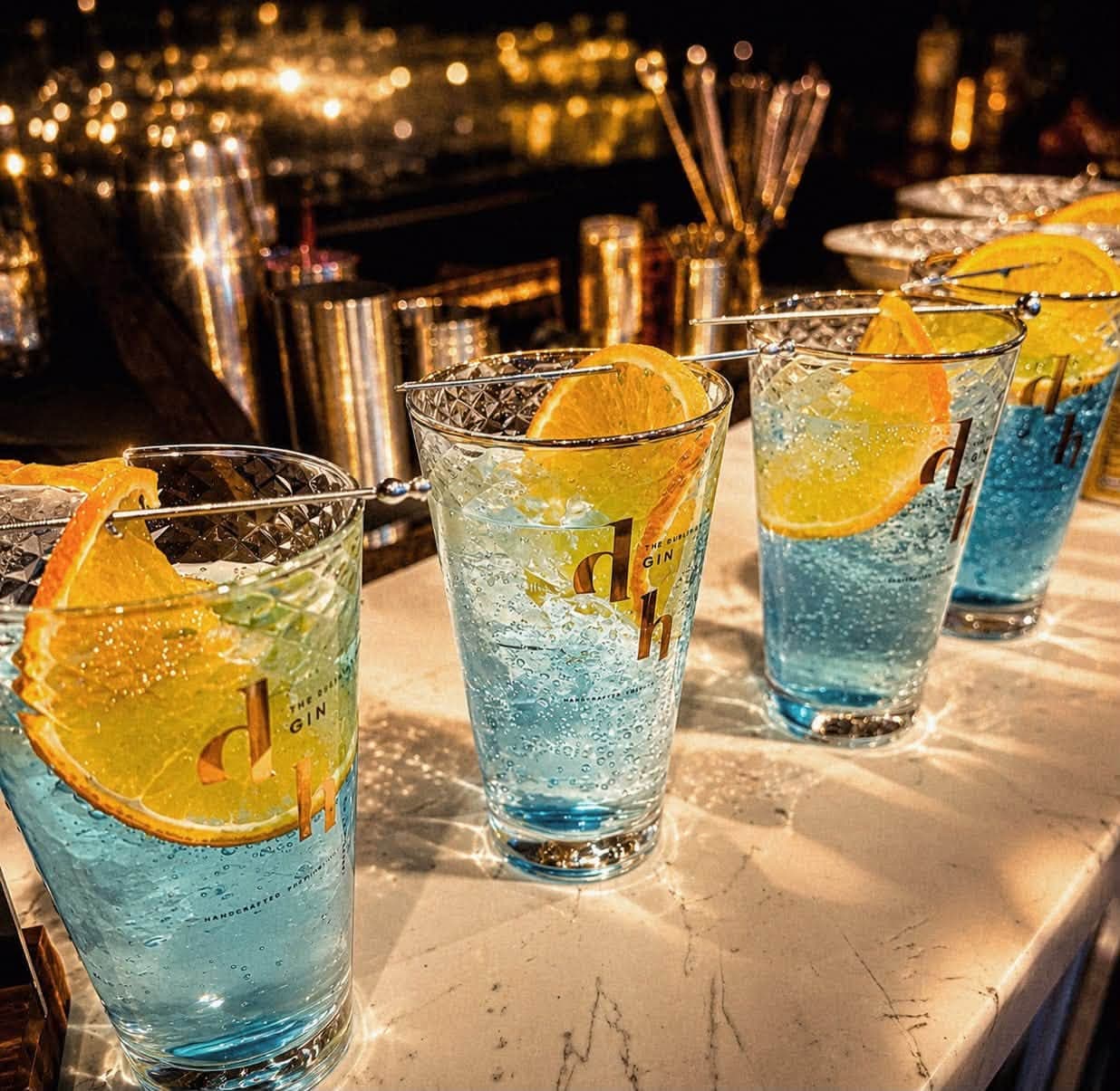 Drunken Horse Blues gin serves with orange slices on the Black Ivory bar